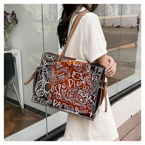 Detail of transparent brown PVC tote bag with white graffiti prints on a model shoulder
