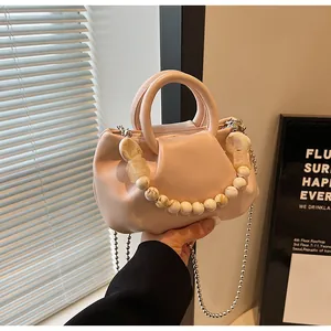 Detailed close-up of pink cloud bag with marble bead chain and silver metal strap