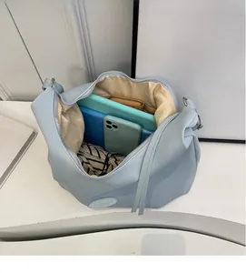 Top view of large light blue tote bag interior showing spacious storage for gadgets