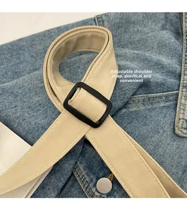 Adjustable shoulder strap detail with black buckle for large capacity beige bucket bag