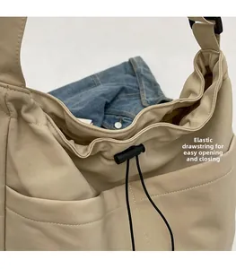 Detail of beige bucket bag featuring an elastic drawstring closure for easy access