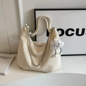 Minimalist beige pebble leather hobo tote bag with silver chain and plush cloud pendant