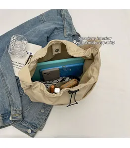 Internal view of beige drawstring bucket bag showing spacious storage for tablet and items