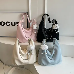 Hobo tote bag in four colors with chain and cloud charm on a white display stand