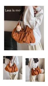 Detail of cargo drawstring bucket bag in brown orange with a cute plush coffee cup charm
