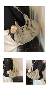 Detail of khaki nylon drawstring bucket bag with spacious pockets and cute plush pendant