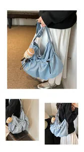 Close-up of light blue nylon drawstring bucket bag with cute plush coffee cup charm