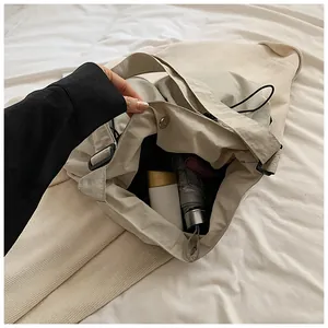 Interior view of spacious drawstring bucket bag showing storage for umbrella and cosmetics