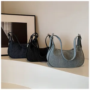 Three color variants of denim hobo bags showing thick woven texture and metal buckles