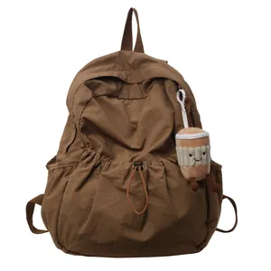 Brown nylon pleated backpack with flap and cute coffee plush charm for school use