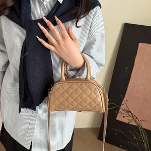 Light brown quilted Boston bag with crossbody strap and double handles for women