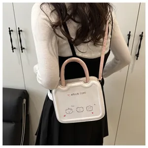 Detail shot of the stylish white and pink crossbody bag with cute character prints