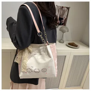 Detail of canvas tote bag featuring cute cartoon print and delicate lace bow accent