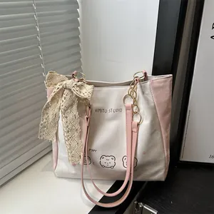Chic cream tote bag with pink straps and cute animal print featuring a lace bow accent