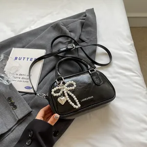 Chic black wrinkled leather boston bag with pearl bow and silver heart pendant