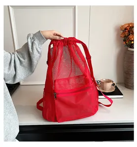 Detail view of the red mesh drawstring backpack with front zipper pocket for training
