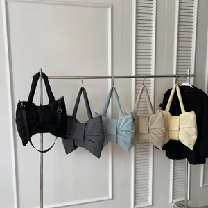 Quilted bow tote bag in five colors including black and khaki with long shoulder strap