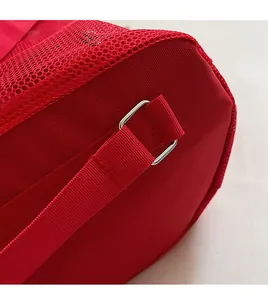 Detail of red drawstring bag featuring premium metal D-ring and breathable mesh fabric