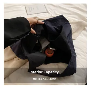 Internal capacity of the nylon tote bag showing cosmetics and personal care items