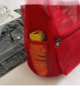 Detail view of red mesh backpack side pocket with a yellow UV-protection umbrella