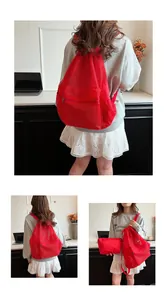 Detail of red mesh drawstring backpack with matching zip pouch and breathable texture