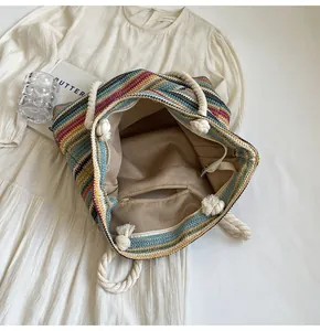Detail of colorful striped woven tote bag with cotton rope handles and fabric lining