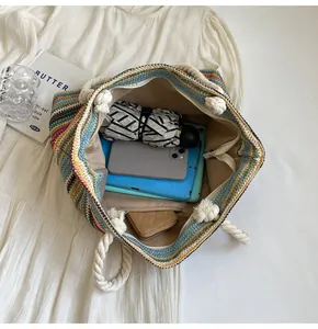 Interior view of colorful striped straw tote bag showing spacious storage for daily items