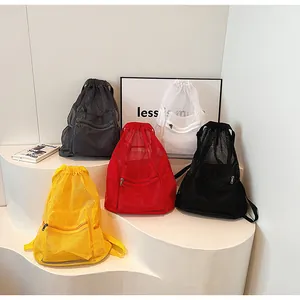 Close-up of multicolored mesh drawstring backpacks with front zipper pockets