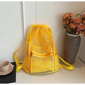 Close-up of bright yellow mesh drawstring backpack with zipper pocket and breathable texture