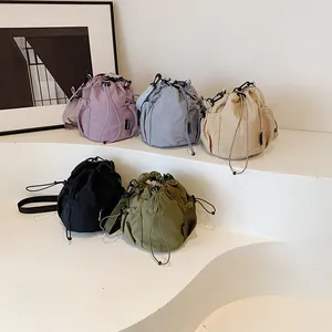 Lightweight nylon drawstring bucket bag in five colors with adjustable shoulder strap