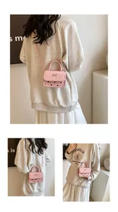 Detailed view of pink mini crossbody bag with metal bow and hollow dot patterns