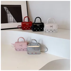 Detailed close-up of mini polka dot crossbody bags for girls in five vibrant colors