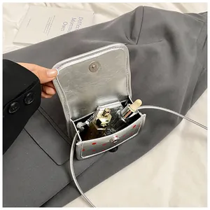Inside view of a silver polka dot mini crossbody bag showing storage for essentials