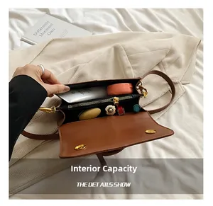 Internal capacity of brown leather crossbody bag with cosmetics and zip pocket