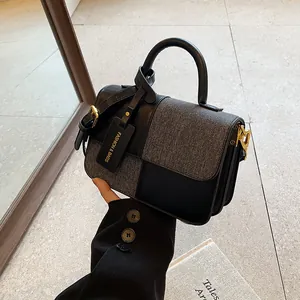Modern patchwork tote bag in black and grey with gold hardware for urban fashion women