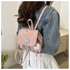 Mini pink fashion backpack featuring a stylish MULUN logo and cute plush ball pendant