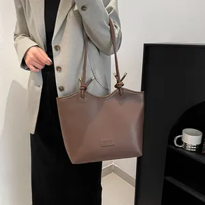 Large capacity dark brown tote bag with matte leather and knot handle detail