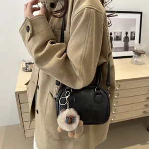 Chic black bowling bag with LUCKY OHIO embossing and cute plush lamb charm accessory