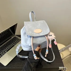 Mini light blue textured backpack with pink drawstring and cute plush pendant decoration