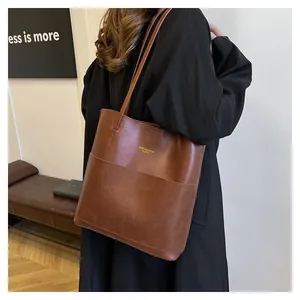 Close-up of vintage brown oil wax leather tote bag with large front pocket detail