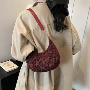 Burgundy leopard print crescent underarm bag with slim red strap for women