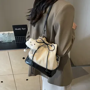 Contrast canvas bucket bag with leather patchwork and cloud charm in a casual scene