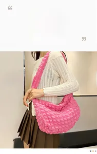 Detailed macro view of pink puff cloud bag featuring textured bubble wrinkle fabric