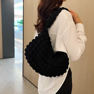 Close-up of black popcorn texture shoulder bag made of soft polyester fabric