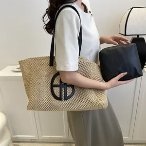 Sac fourre-tout en paille tissée avec logo noir circulaire et pochette intérieure assortie