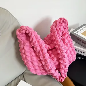 Close-up of pink bubble cloud bag showing waffle texture and soft pleated fabric