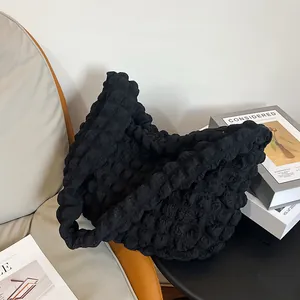 Close-up of the unique 3D popcorn fabric texture on this black hobo shoulder bag