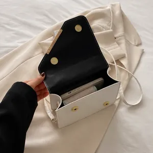 Capacity display showing white quilted handbag with magnetic closure and interior space