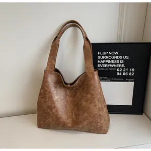 Detail of vintage brown tote bag with marble leather texture and sturdy double straps