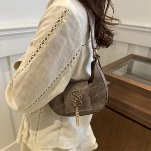 Retro brown canvas half-moon hobo bag with gold metal S logo and elegant fringe tassel